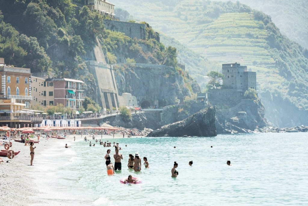 People swimming at castle and hills of Monterosso in Cinque Terre