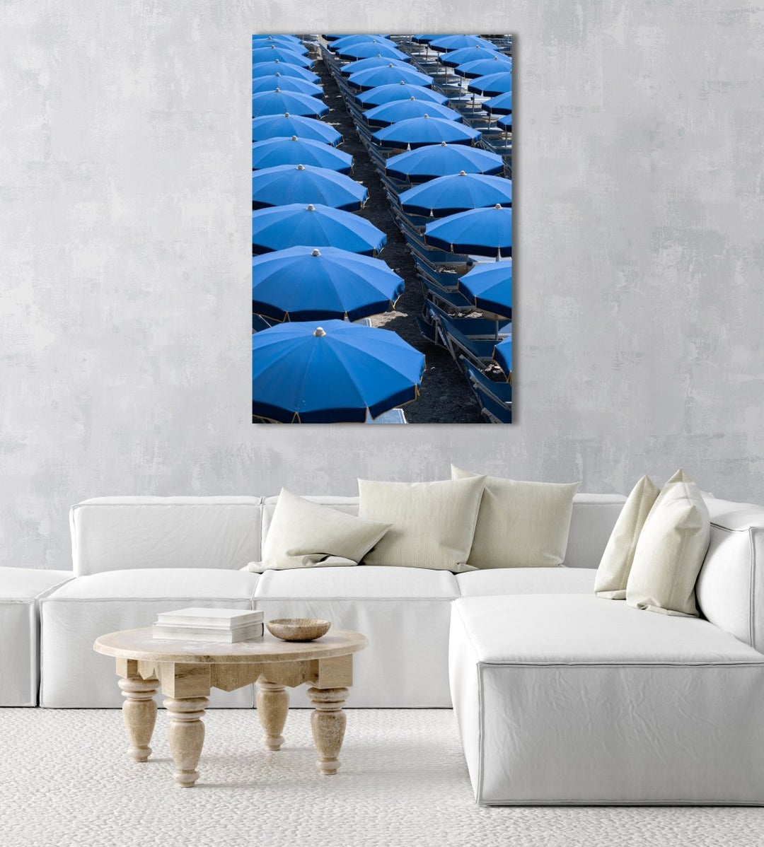 Blue umbrellas and beach chairs lined up in Italy in an acrylic/perspex frame