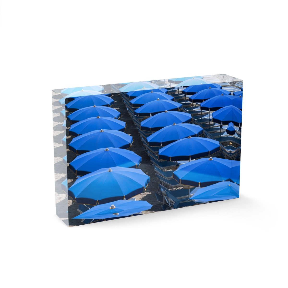 Rows of blue umbrellas and chairs on italian beach