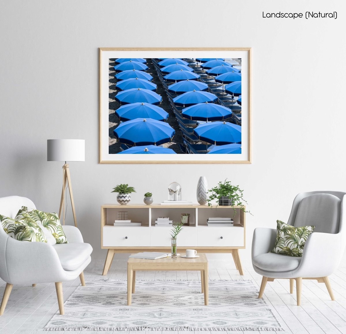 Rows of blue umbrellas and chairs on italian beach in a natural fine art frame