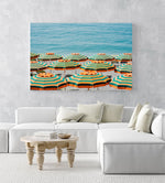 Rows of striped orange umbrellas and turquoise sea in Cinque Terre in an acrylic/perspex frame