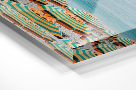 Rows of striped orange umbrellas and turquoise sea in Cinque Terre in an acrylic/perspex frame