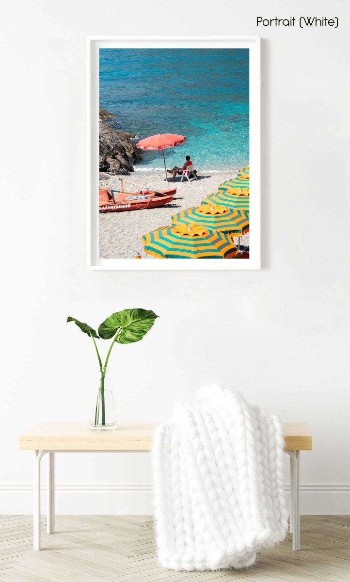 Italian lifeguard sitting under umbrella with boat at blue water on Monterosso Beach in a white fine art frame
