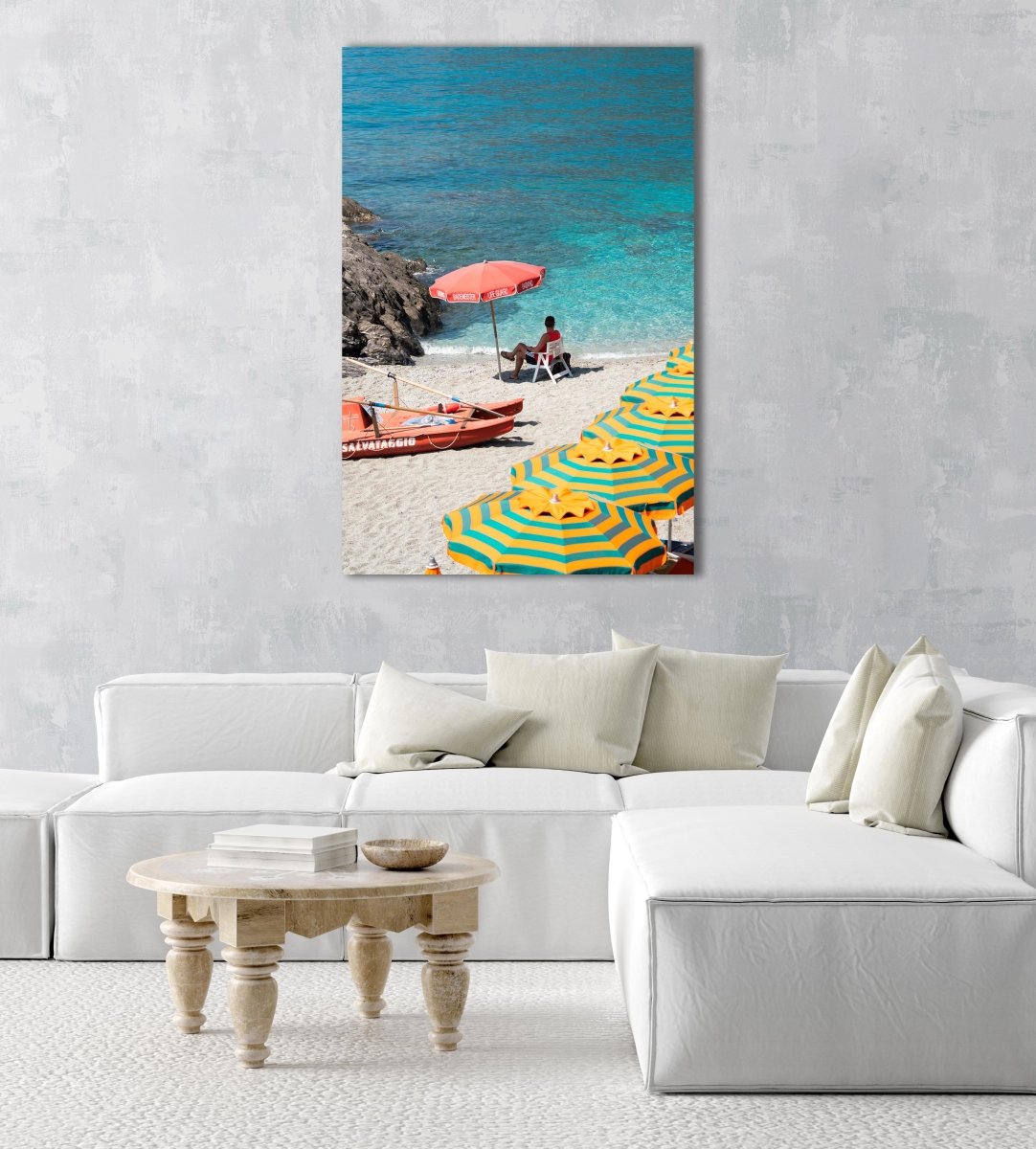 Italian lifeguard sitting under umbrella with boat at blue water on Monterosso Beach in an acrylic/perspex frame