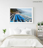 Rows of blue umbrellas along blue mediterranean sea in Cinque Terre in a white fine art frame