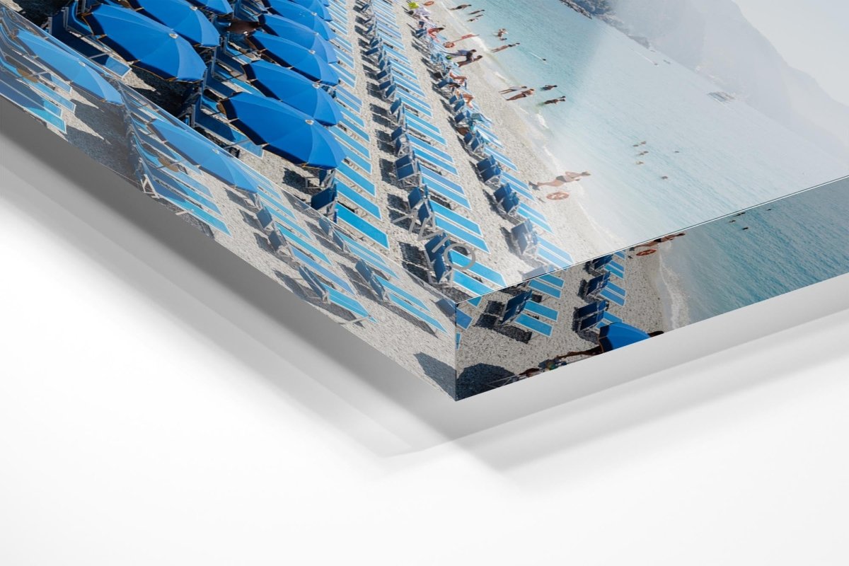 Rows of blue umbrellas along blue mediterranean sea in Cinque Terre in an acrylic/perspex frame