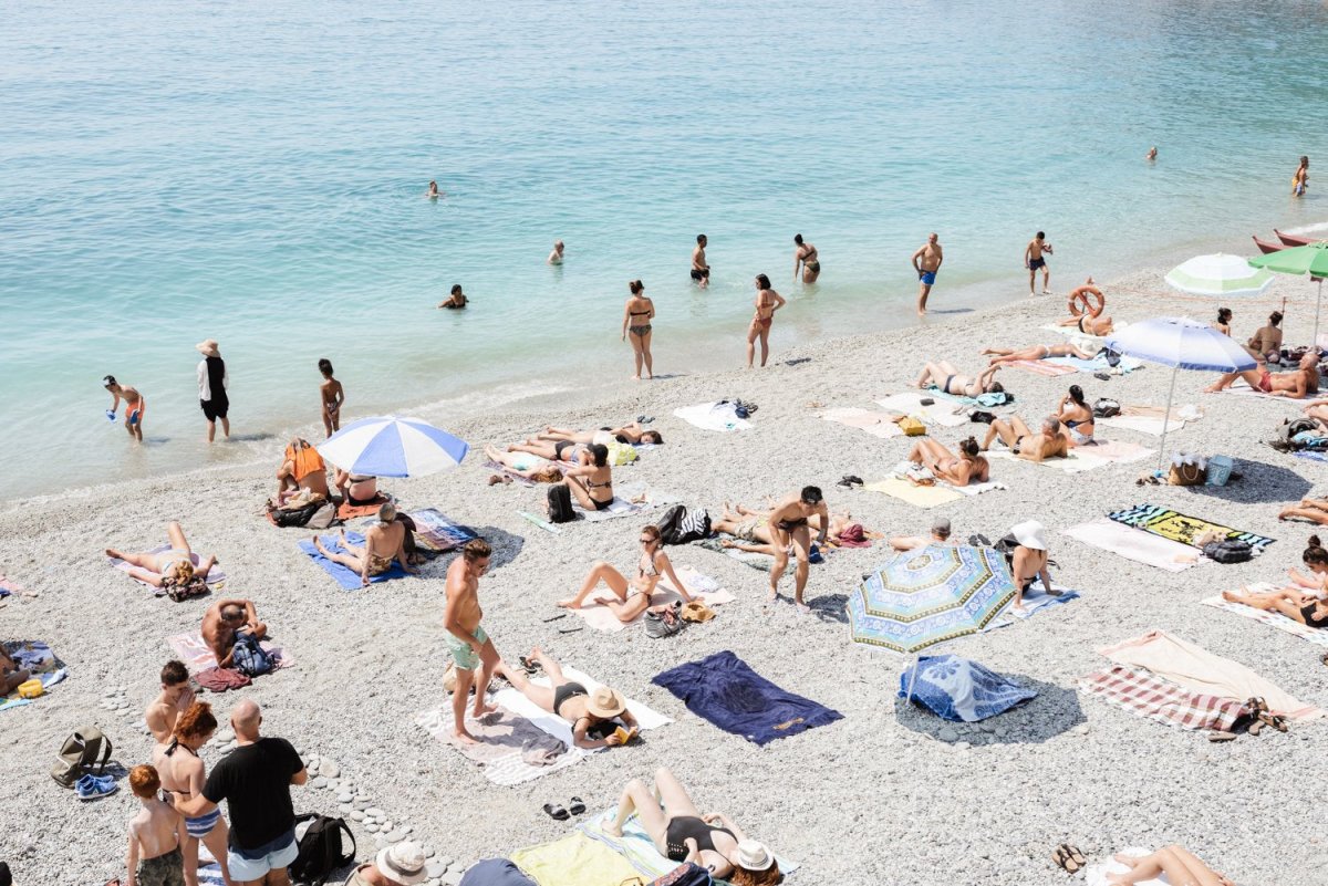 Beach goers lying on sand at italian beach