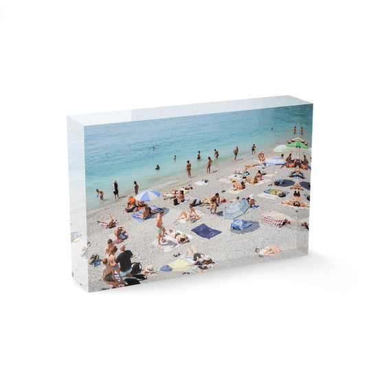 Beach goers lying on sand at italian beach