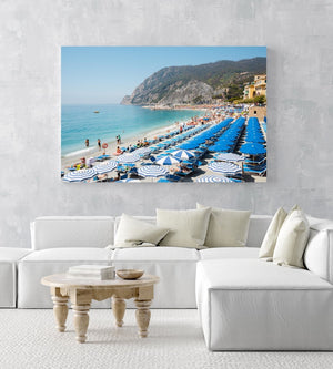 People and umbrellas at Monterosso beach Cinque Terre during summer in an acrylic/perspex frame