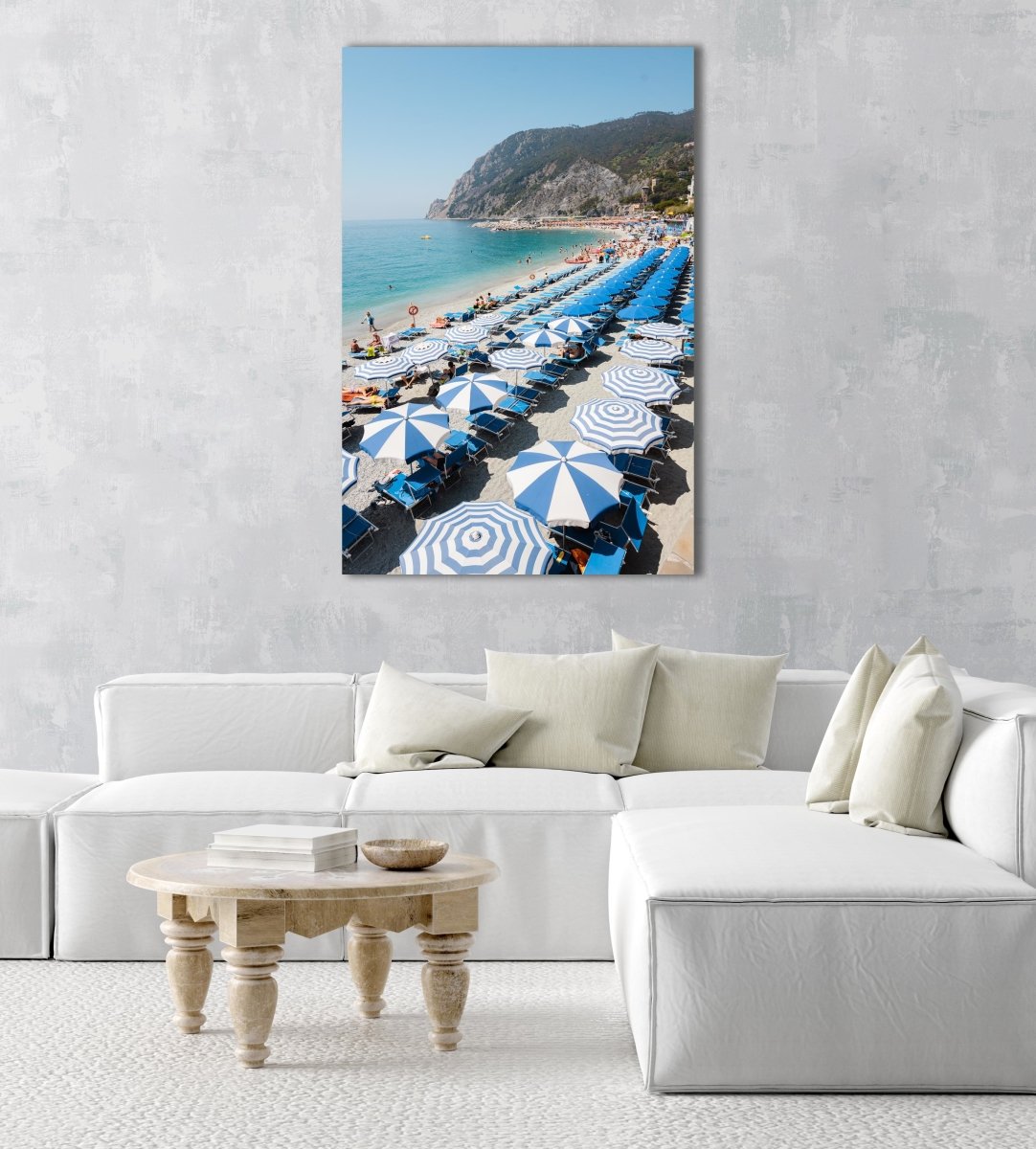People and umbrellas at Monterosso beach Cinque Terre during June in an acrylic/perspex frame