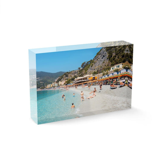 People swimming and sitting at colorful Monterosso beach in Cinque Terre