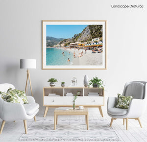People swimming and sitting at colorful Monterosso beach in Cinque Terre in a natural fine art frame