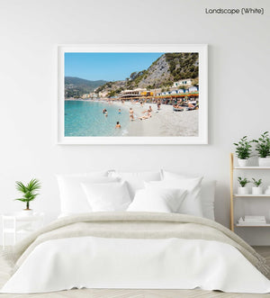 People swimming and sitting at colorful Monterosso beach in Cinque Terre in a white fine art frame
