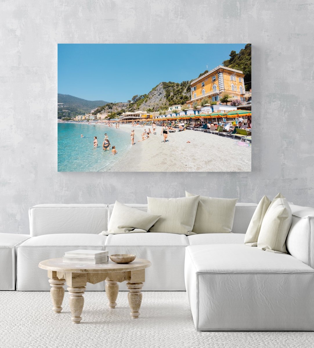 People swimming and sitting at colorful Monterosso beach in Italy in an acrylic/perspex frame