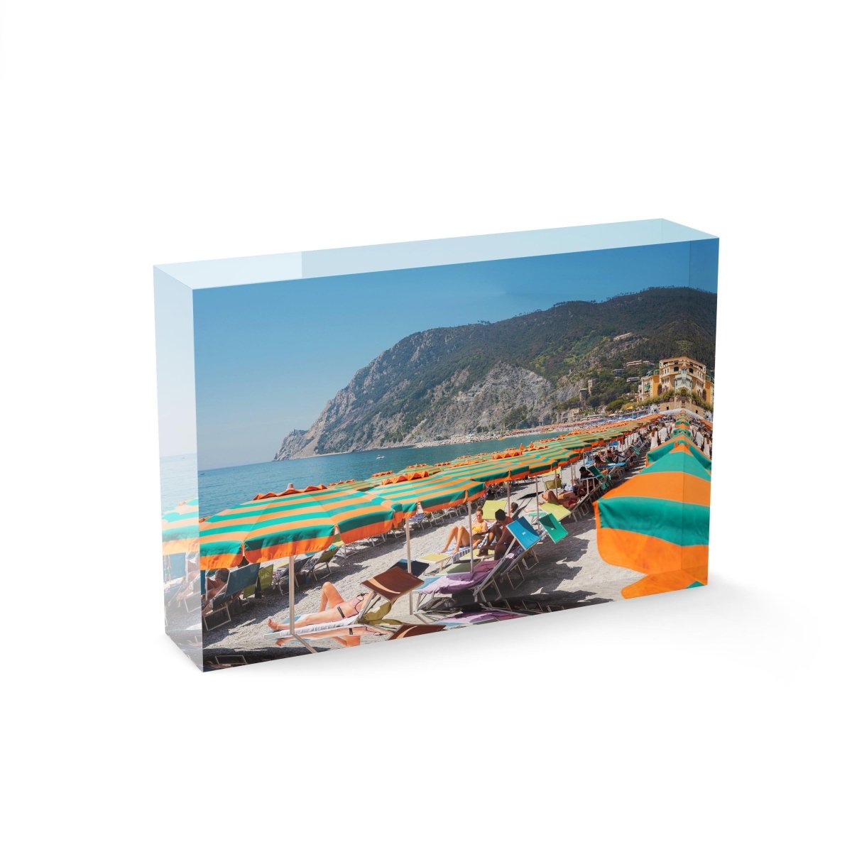 Orange umbrellas and people tanning on Monterosso Beach Cinque Terre