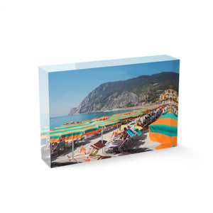 Orange umbrellas and people tanning on Monterosso Beach Cinque Terre