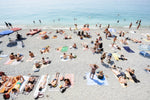 People lying on Monterosso beach with pebbles in Cinque Terre