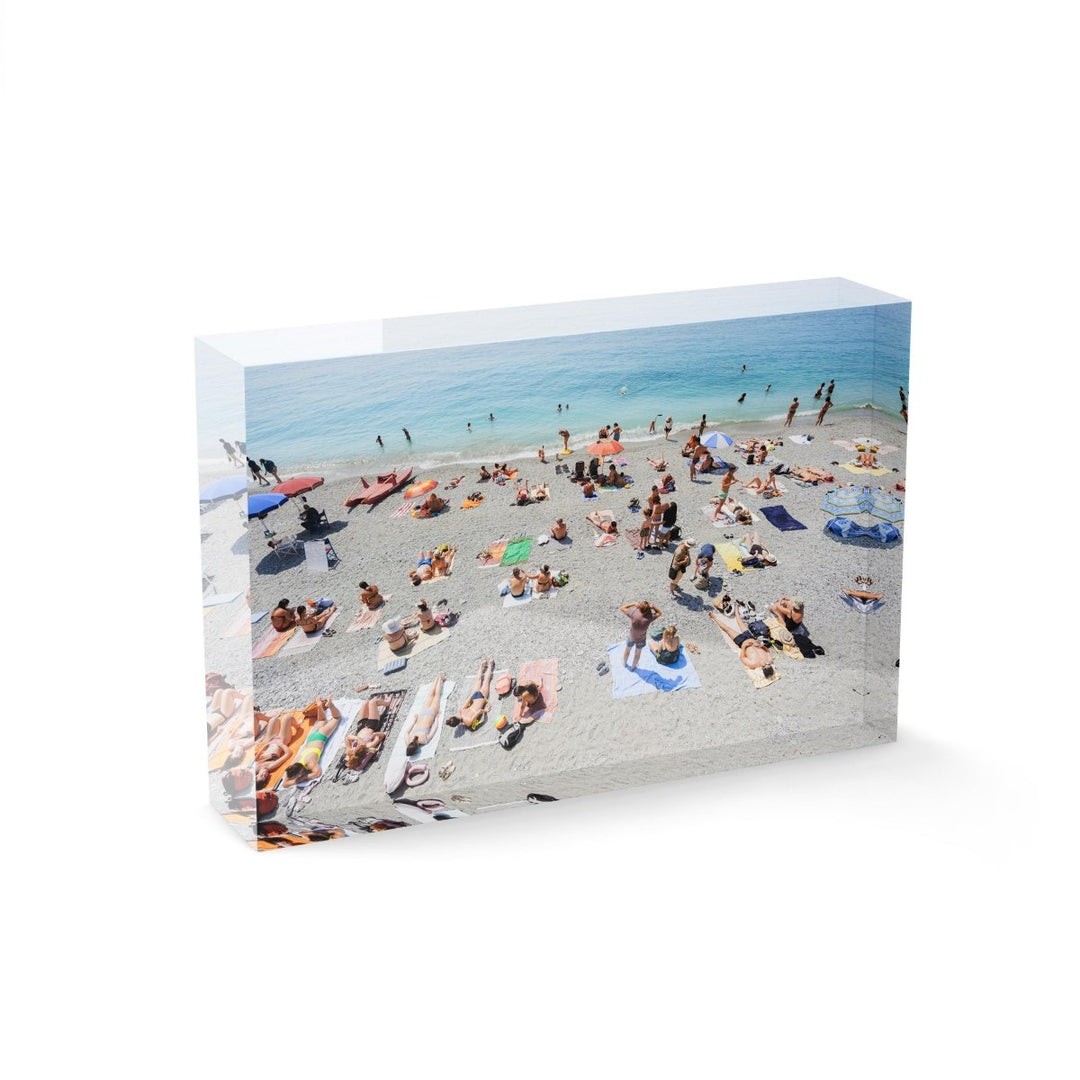 People lying on Monterosso beach with pebbles in Cinque Terre