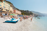 People swimming and lying on italian beach during summer
