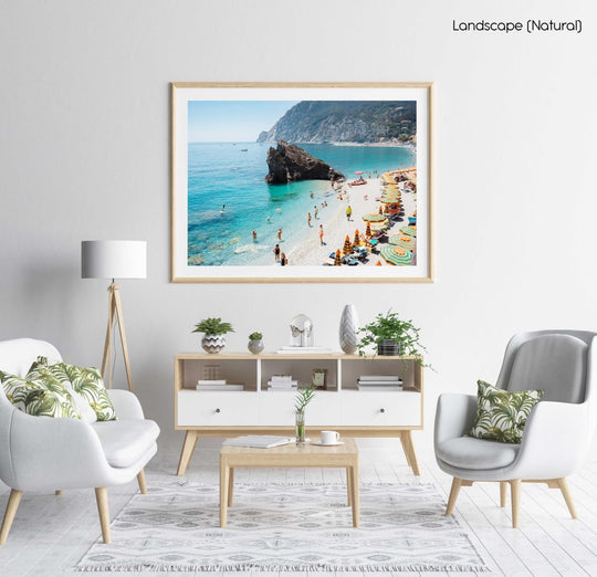 Big rock on Monterosso beach surrounded by people and blue water Cinque Terre in a natural fine art frame