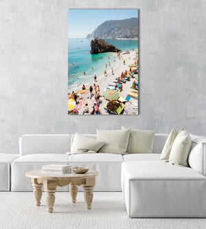 Big rock on Monterosso beach surrounded by people and blue water in Italy in an acrylic/perspex frame