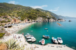 Boats docked along promenade of old town Monterosso during summer in Cinque Terre