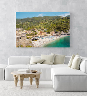 The old town of monterosso with people on beach and green hills in an acrylic/perspex frame