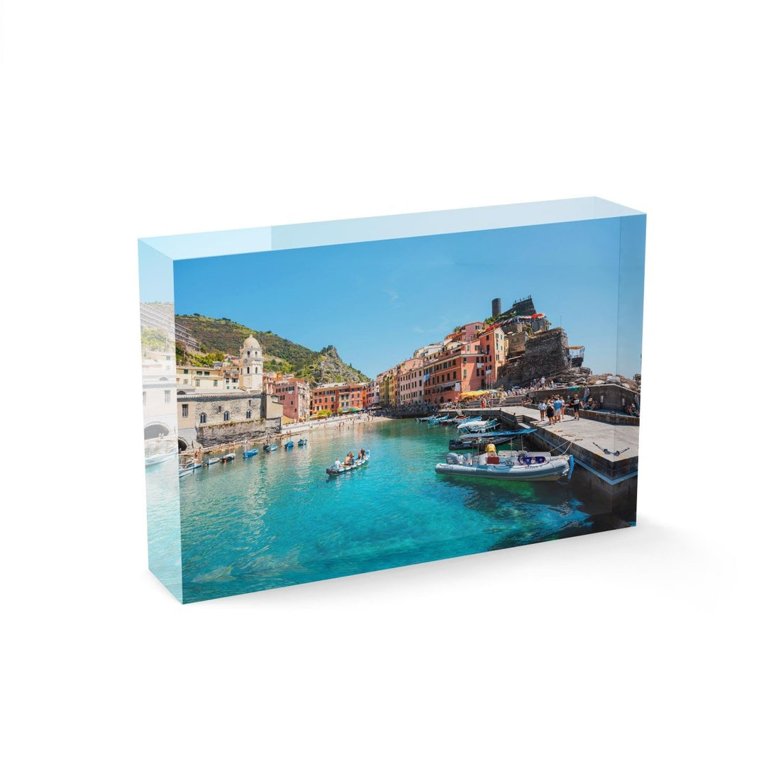 People on boat in blue water in colorful Vernazza of Cinque Terre