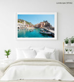 People on boat in blue water in colorful Vernazza of Cinque Terre in a white fine art frame