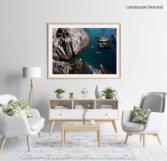 People swimming along dark rocks in Manarola Cinque Terre in a natural fine art frame