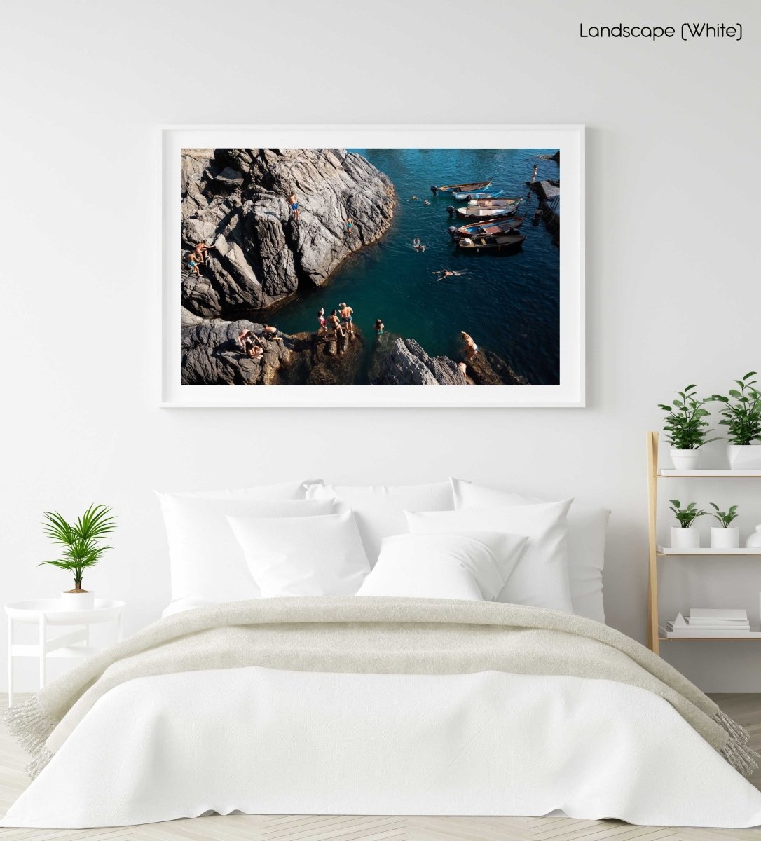 People swimming along dark rocks in Manarola Cinque Terre in a white fine art frame