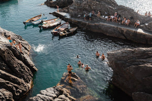 People jumping off rocks at Manarola in Cinque Terre
