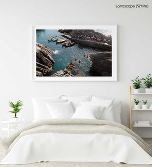 People jumping off rocks at Manarola in Cinque Terre in a white fine art frame