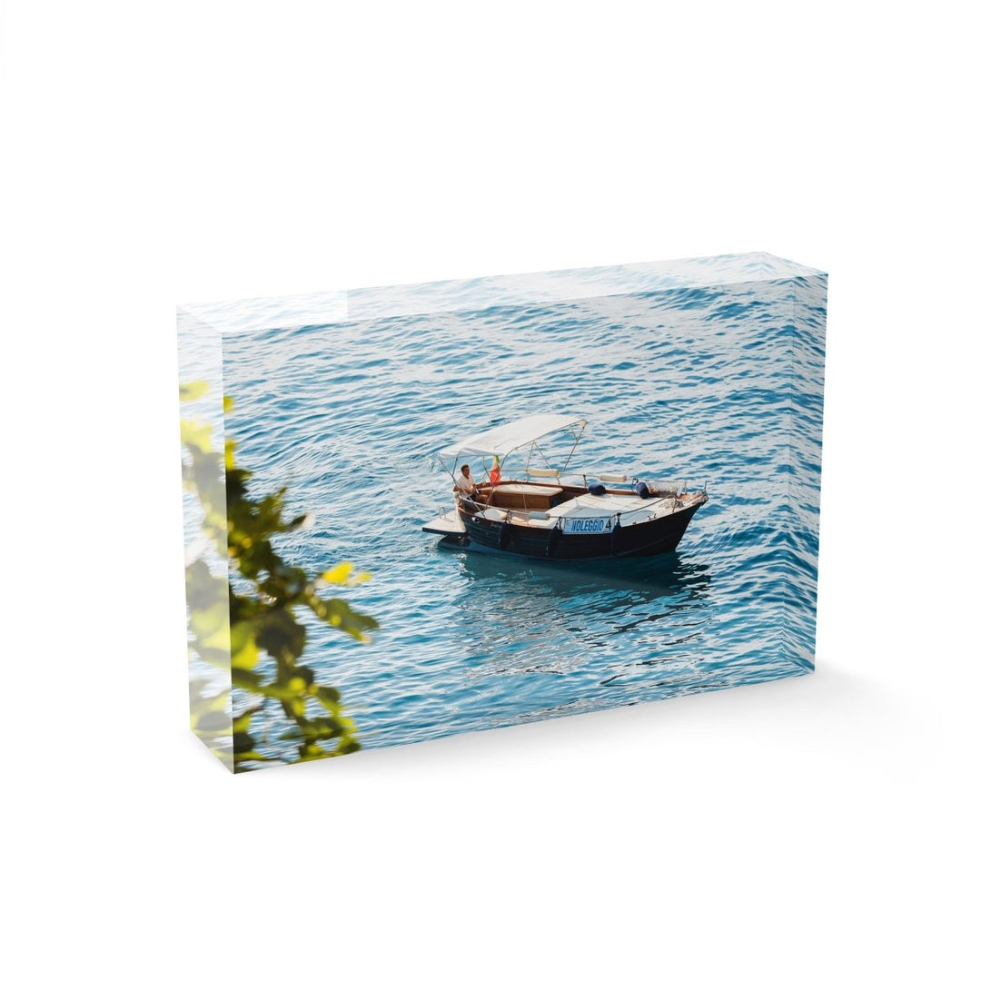 Man driving a rental boat along Cinque Terre coastline