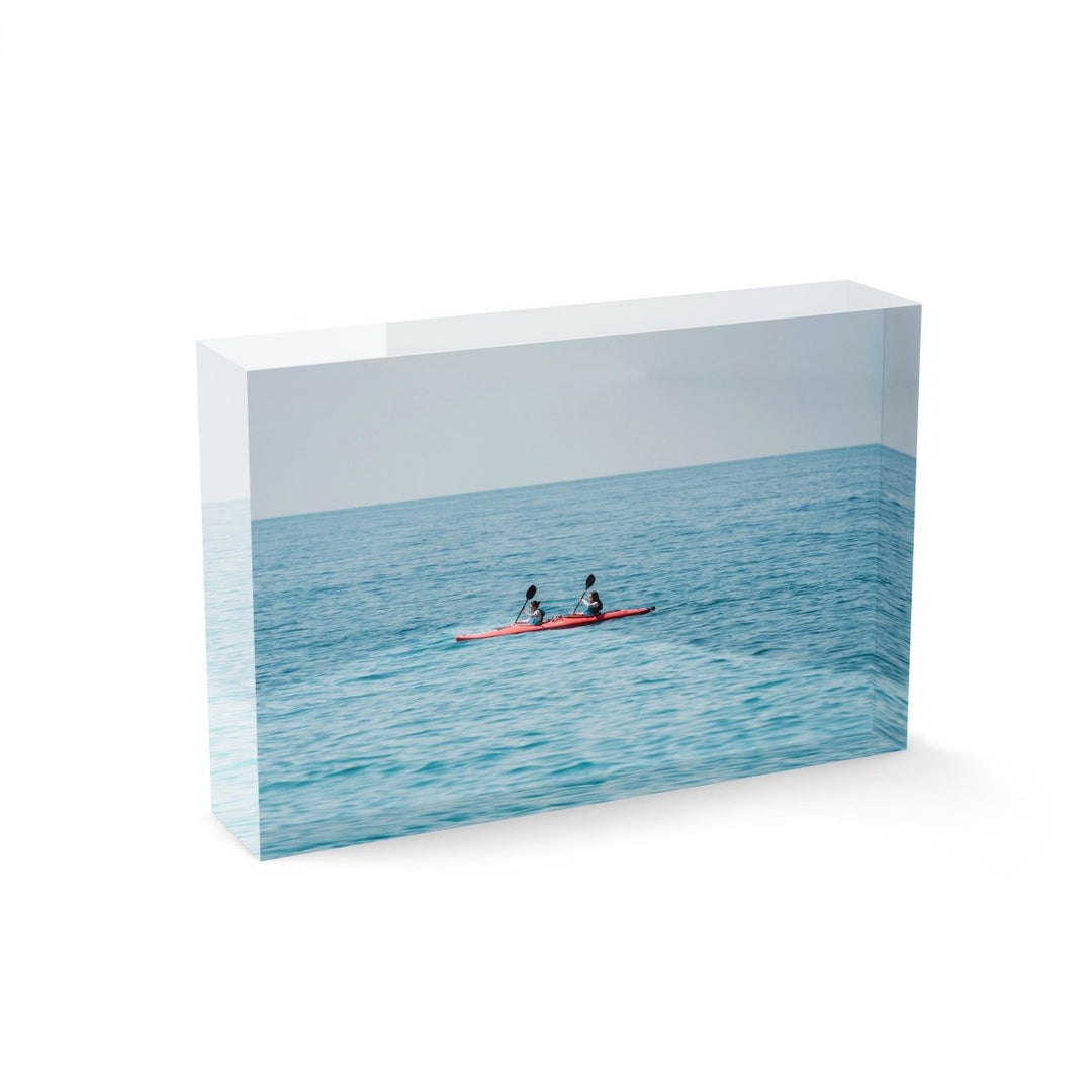 Two women paddling a red kayak in Cinque Terre