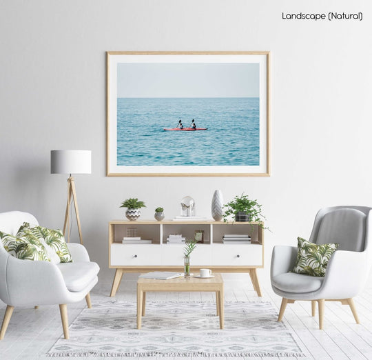 Two women paddling a red kayak in Cinque Terre in a natural fine art frame