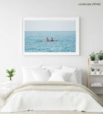 Two women paddling a red kayak in Cinque Terre in a white fine art frame