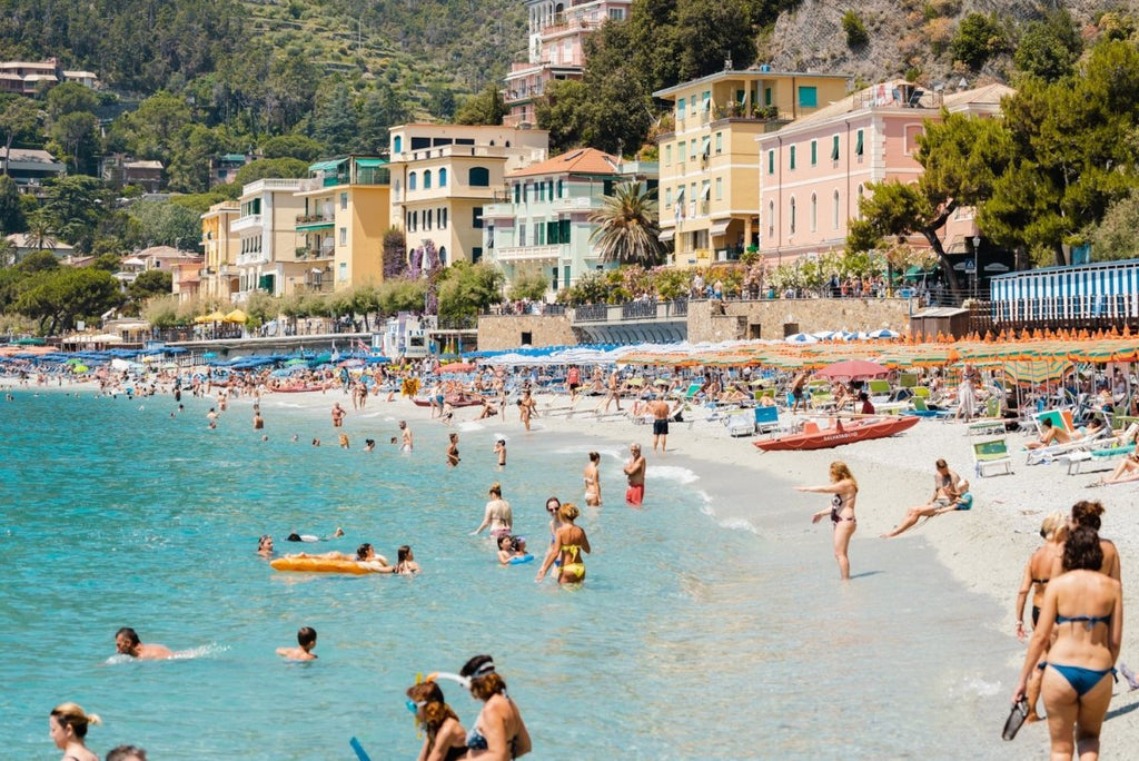 Busy Monterosso beach with people swimming, snorkeling and chilling on summers day