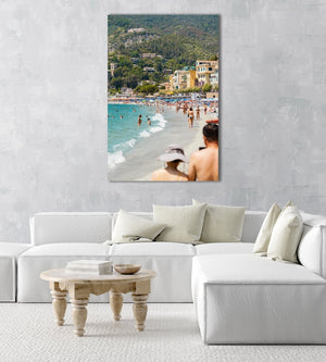 People walking and swimming in blue water of Monterosso beach in Cinque Terre in an acrylic/perspex frame