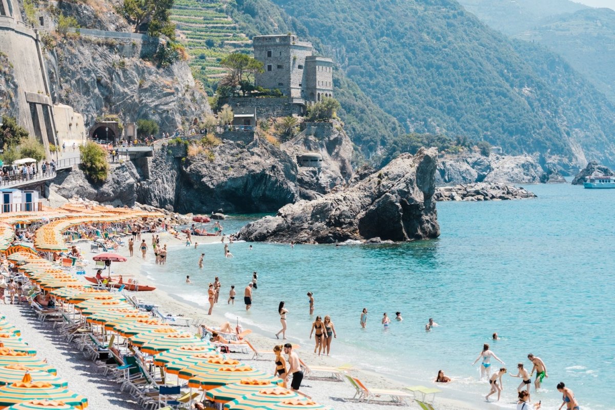 People enjoying the sun and ocean in Cinque Terre