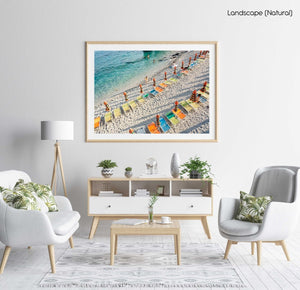 Orange, green and blue chairs on beach in Cinque Terre in a natural fine art frame