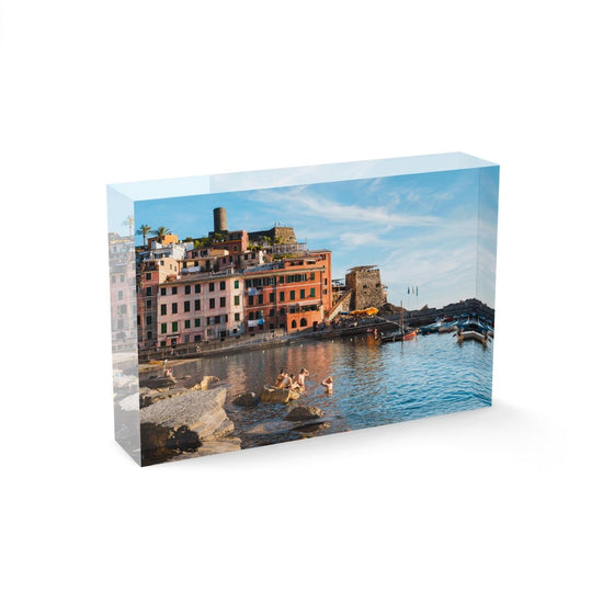 People swimming at Vernazza beach near buildings