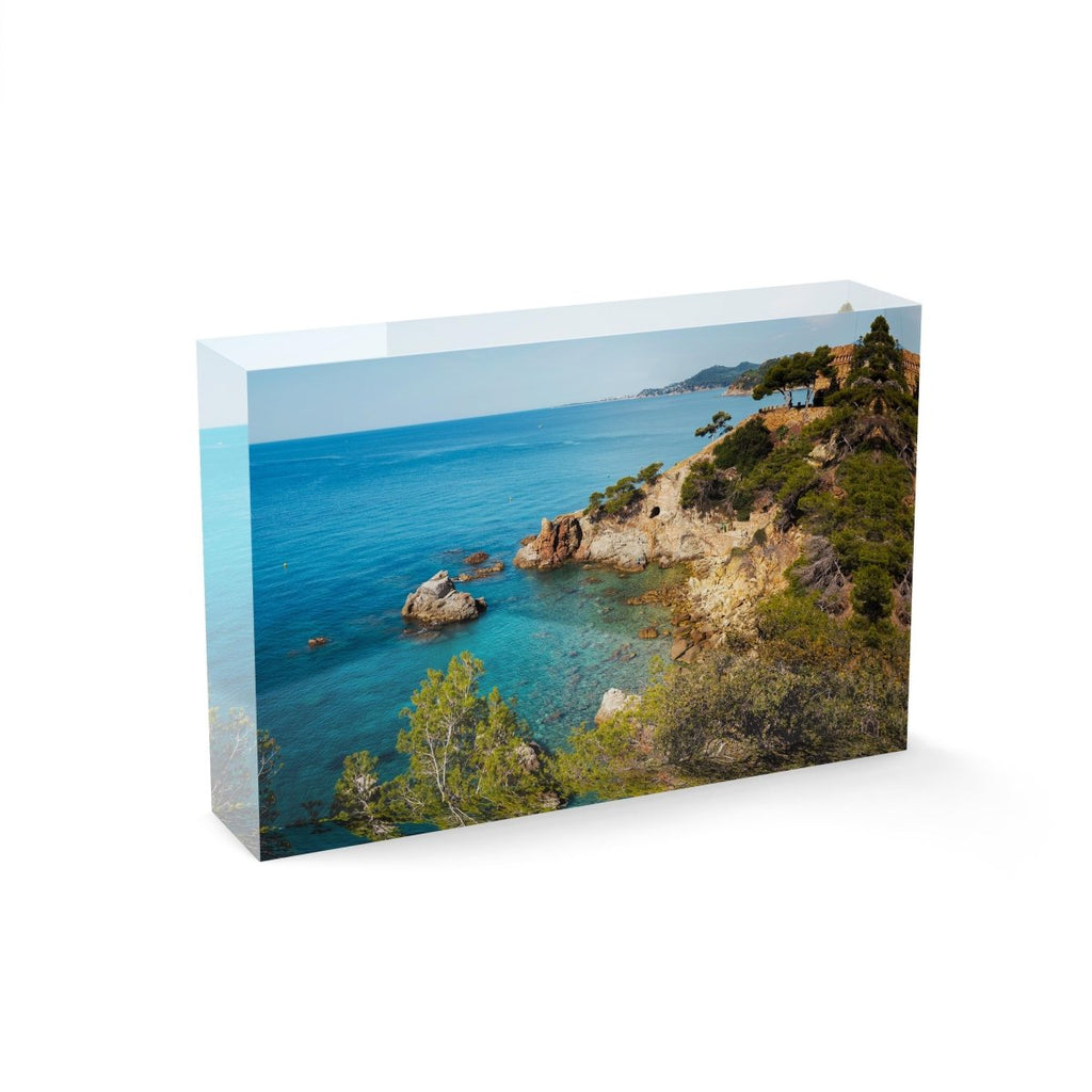 Green trees and bright blue water along Costa Brava coast
