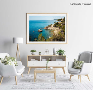 Green trees and bright blue water along Costa Brava coast in a natural fine art frame