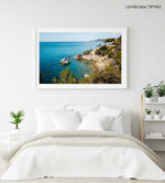 Green trees and bright blue water along Costa Brava coast in a white fine art frame