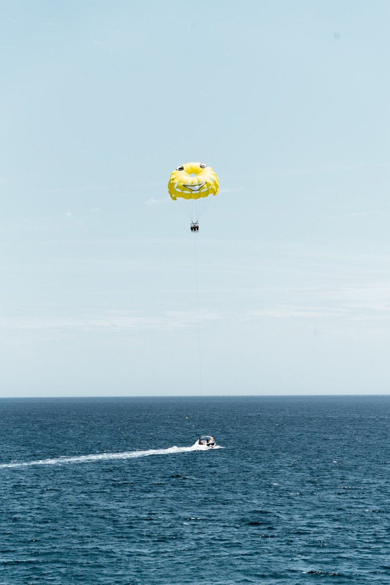 Yellow parasail behind boat in Costa Brava Spain