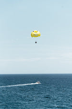Yellow parasail behind boat in Costa Brava Spain