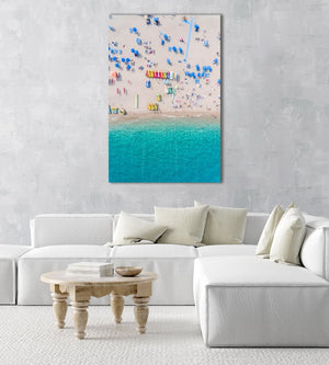 Colorful umbrellas, boats and water seen from air above Lloret de Mar beach in a white fine art frame