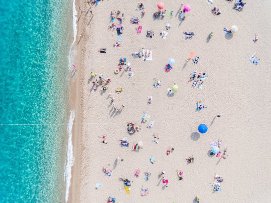 Busy beach day in Lloret de Mar during summer from aerial point