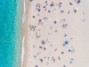 Busy beach day in Lloret de Mar during summer from aerial point